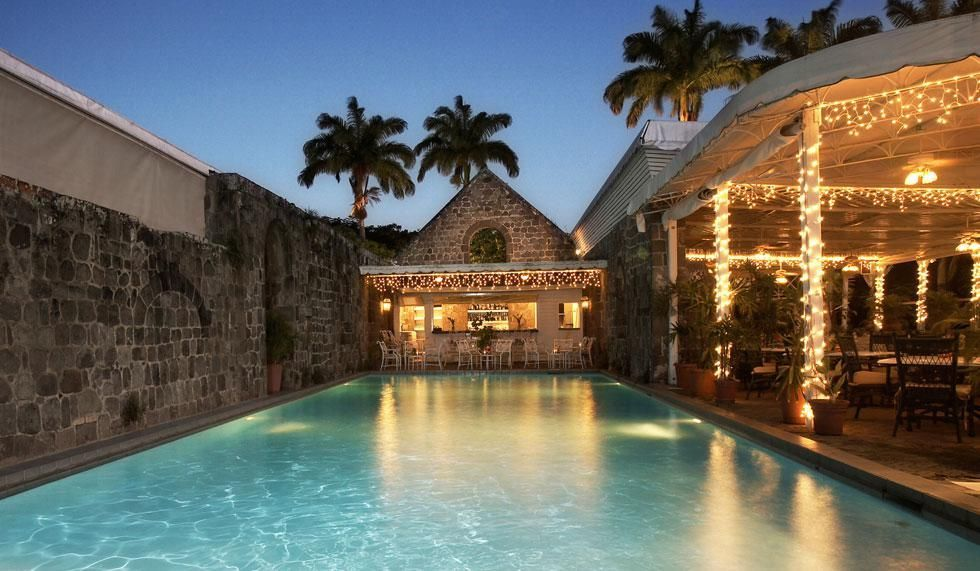 Pool and restaurant lit at dusk